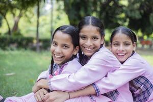 Three Skilled Girl Students Smiling While Making Craft photo