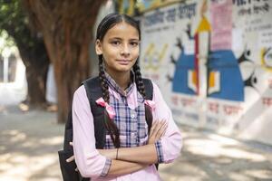 Indian Village Shy Girls In School Uniform Holding Slate In Hand While Posing In Front Of Camera photo