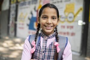 Cute Kid Standing While Holding Slate In Hand With Written Text ''Back To School'' photo