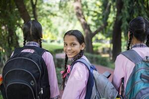 Confident Student Standing While Holding Slate In Her Hand With Written Text ''Back To School'' photo