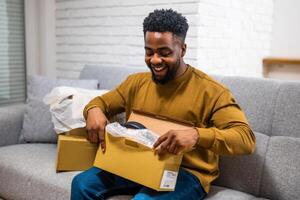 Young black man holds a package with a smile as he enjoys the quick and reliable express delivery from his online shopping experience. The scene emphasizes consumer satisfaction. photo