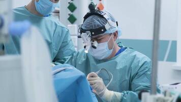 Operation of removing tonsils under deep anesthesia, throat close up, surgeon uses latest devices, cold plasma method, cuts swelling in throat, doctor works with new probe 53 video