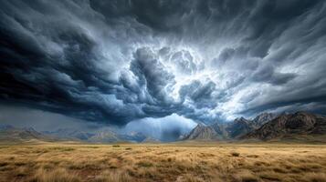 A stormy sky over a field with mountains in the background photo