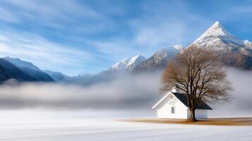A small white house sits on the snow covered ground photo