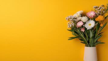 A vase with flowers on a yellow background photo