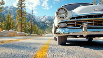 A classic car driving down a road in the mountains photo