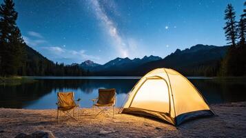 A tent and chairs by a lake at night photo