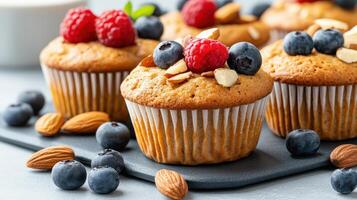 A tray of muffins with berries and almonds photo
