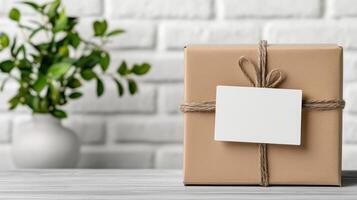 Brown gift box with blank label on wooden table photo