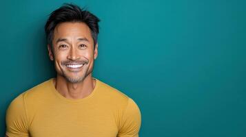 A man in a yellow shirt smiling photo
