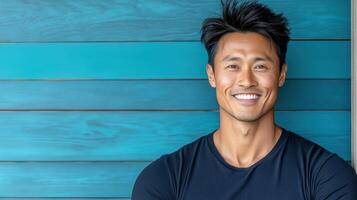A man with a black shirt and blue wall photo