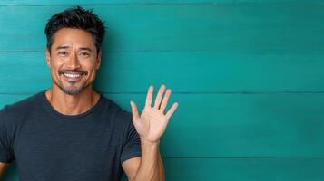 A man is smiling and waving his hands photo