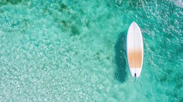 An aerial view of a surfboard floating in the ocean photo