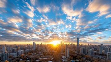 The sun rises over a city skyline with clouds photo