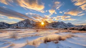 The sun rises over the mountains in winter photo