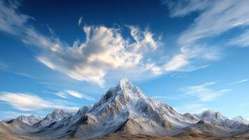 A mountain range with snow on top and clouds in the sky photo