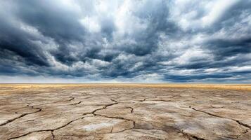 A dry desert with clouds and dark sky photo