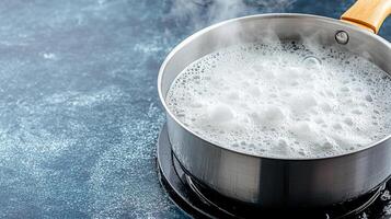A pot of boiling water with a wooden spoon photo