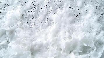 A close up of a wave with bubbles and water photo