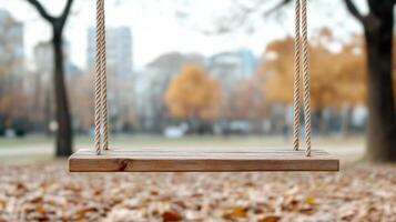 A wooden swing in the middle of a park photo
