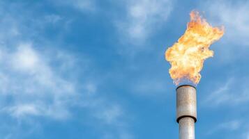 A gas flame is seen on a metal pipe photo