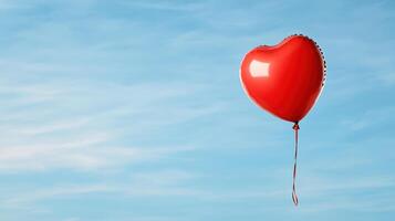 A red heart shaped balloon is floating in the sky photo