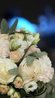Wedding bouquet on the table in the Banquet hall. Guests dance in the background in blurred out of focus. video