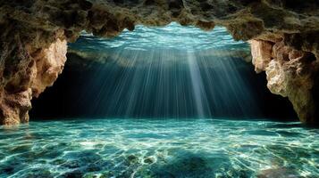 A cave with water and sunlight coming through photo
