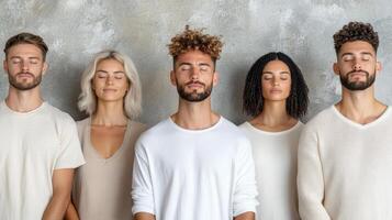 Five people standing in a row with their eyes closed photo