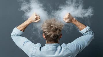 A man is holding his hands up in the air with smoke coming out of his head photo