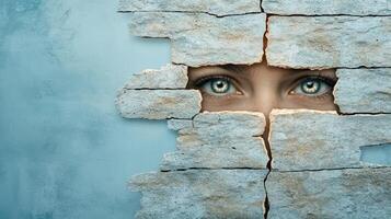 A woman peeking through a hole in a wall photo