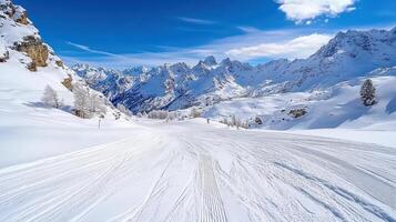 A snowy mountain road with a blue sky photo
