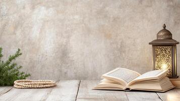 Open book with lantern and prayer beads on wooden table photo