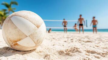 A volleyball ball on the beach with people in the background photo