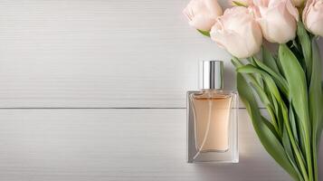 A bottle of perfume and a bouquet of tulips on a white background photo