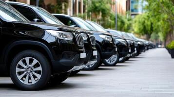 A row of black suvs parked on a street photo