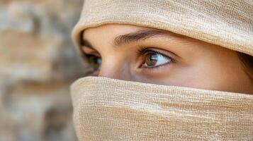 A woman with a scarf covering her eyes photo