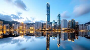 Hong kong skyline at dusk with reflection in water photo