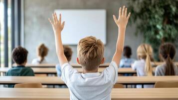 A child raising their hands in front of a classroom photo