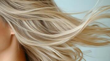 A woman with long blonde hair blowing in the wind photo