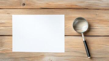 Blank paper and magnifying glass on wooden table photo