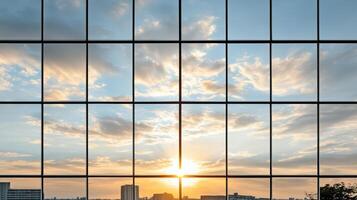 A view of the sun setting through a glass building photo