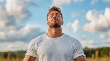 A man is meditating in a field photo