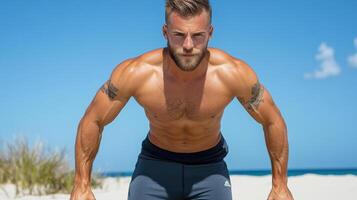 A shirtless man on the beach with his hands on his hips photo