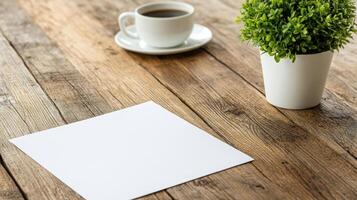 Blank paper and cup of coffee on wooden table photo