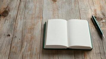 A notebook and pen on a wooden table photo