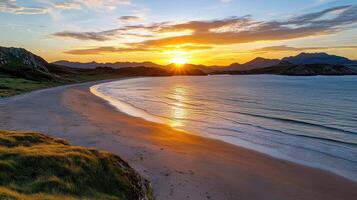 Sunset over the sea at the beach in the isle of man, scotland, photo