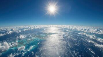 The sun shines over the earth and the clouds photo