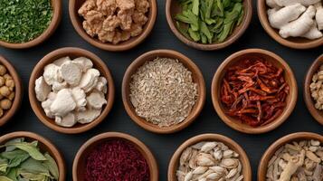 Various types of herbs and spices in wooden bowls photo