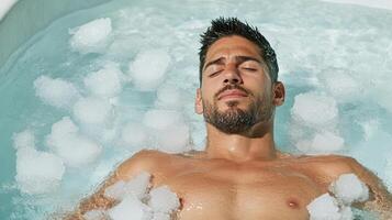 A man relaxing in a hot tub with bubbles photo